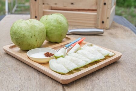 Guava and sugar chili sauce in wooden dish on wood table.の写真素材