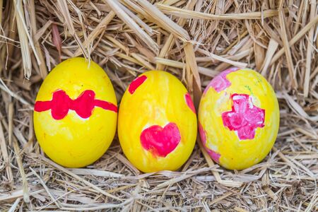 Easter eggs color yellow coloring Heart, Bow and Red Cross emblem.の写真素材