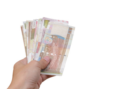 Hand holding Hong Kong banknote isolated on white background. clipping path in picture.