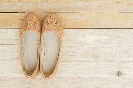 Female shoes on wood background. top view.の写真素材