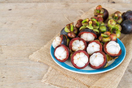 Thai fruit Mangosteen on wood table. It is queen fruit in Thailand.の写真素材