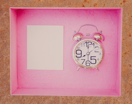 Alarm clock and gift box with copy space. Vintage or Retro tone. top view.の写真素材