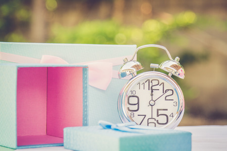 Alarm clock and gift box with copy space. Vintage or Retro tone.の写真素材