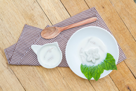 Coconut jelly coconut milk in cup on wood background local dessert thailand. Top view.の写真素材