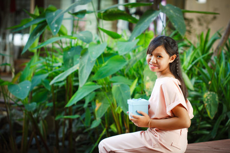 Asia girl give the gift box on the eve of the festival with copy space.の写真素材