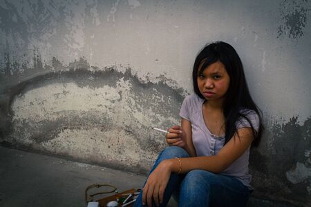 Concept Asia young girl is sad by drug addiction. Drug addiction in adolescence.の写真素材