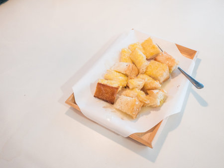 Toast with topped with butter, condensed milk and sugar in restaurant.