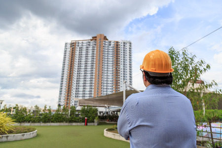 Businessman wear a hat for the construction looking architecture outdoor.の写真素材