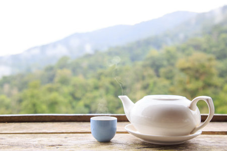 Tea pot and tea cup hot or warm on wood table with copy space background nature.の写真素材