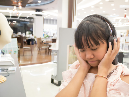 Asia girl listen to the music with headphones at relax time.の写真素材
