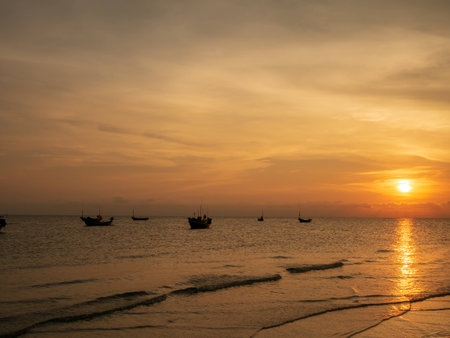 Sunset at the sea and boat with copy space at Chao Lao Beach, Chanthaburi Province, Thailand.の写真素材