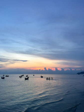 Sunset at the sea and boat with copy space at Chao Lao Beach, Chanthaburi Province, Thailand.