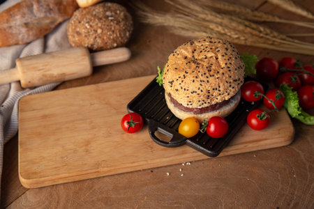 Hamburger homemade on wood table with copy space.