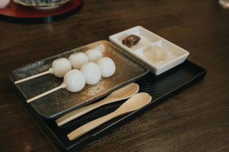 Dango is Sweet dessert make rice flour with skewer on wooden table in restaurant. Japanese traditional style.の写真素材