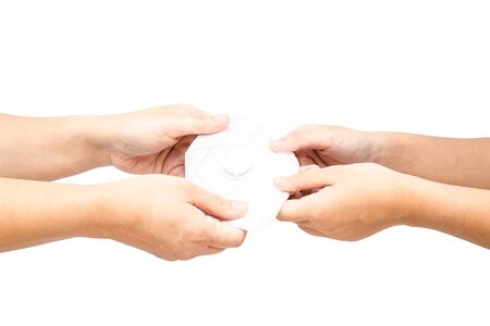 Using his hands to give an anti-virus or coronavirus or covid-19 or anti-dust mask isolated on white background with copy space and clipping path in picture.の写真素材