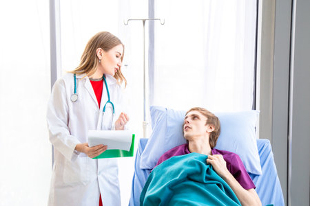 The female doctor is wearing a doctor uniform examining the symptoms of a patient is stomach ache patient sitting in bed. Concept examination of the symptoms of stomach ache.の写真素材
