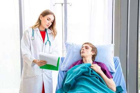 The female doctor is wearing a doctor uniform examining the symptoms of a patient is stomach ache patient sitting in bed. Concept examination of the symptoms of stomach ache.の写真素材