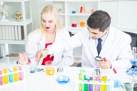 Male and Female Scientists or doctor are trying to find a vaccine against germs Such as the corona virus or COVID 19 in a laboratory.の写真素材