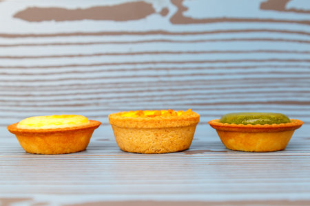 Mango tart, Egg tart and Steamed custard tart on a wood with copy space.
