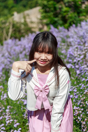 A gentle moment amid vibrant purple flowers, embracing nature's peaceful beauty.の写真素材