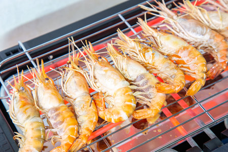 Cooking grilled shrimp with an electric grill by grilled on Steel grating The bottom has a hot conductive wire which was so hot that it was red.の写真素材