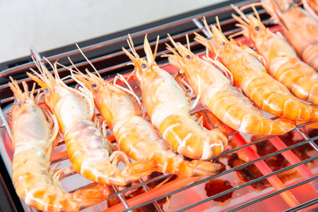 Cooking grilled shrimp with an electric grill by grilled on Steel grating The bottom has a hot conductive wire which was so hot that it was red.の写真素材