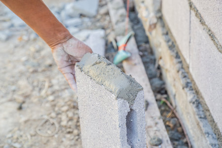 Worker masonry are building walls with cement blocks and mortar by building up in layers.の写真素材