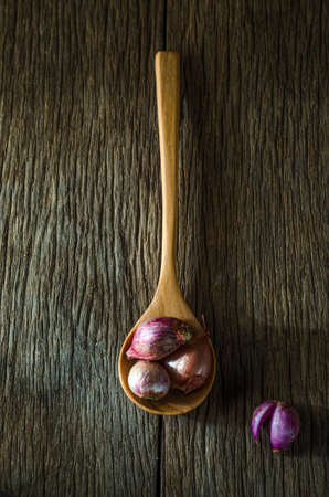 still life of onions in a wooden spoonの写真素材