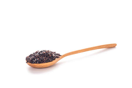Rice berry in wooden spoon. White backgroundの写真素材