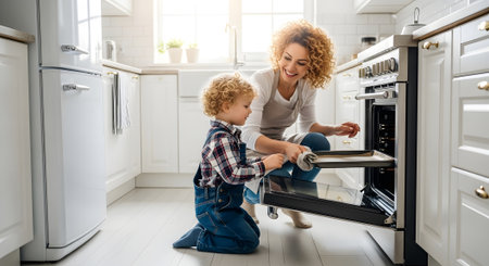 Beautiful young mother and her cute little son are cooking together in the kitchen at home.の素材