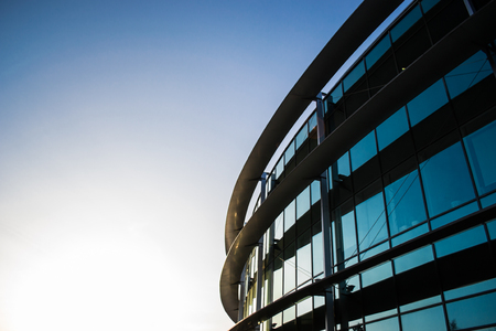 Glass modern round metal building sunsetの写真素材