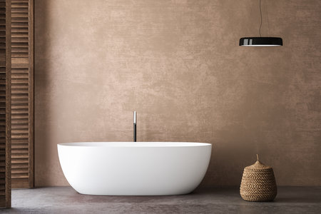 A serene bathroom with beige walls and concrete flooring. Natural light floods in from the side, illuminating a white bathtub and a basket. A perfect combination of minimalism and warmth.3d renderingの写真素材