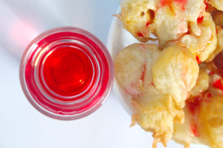 Indonesian style fried banana and refreshing sweet red strawberry drinking water