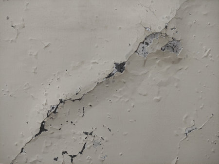 The texture of the walls is cracked, cracked and bubbling due to the weather and has to be repaired over timeの写真素材