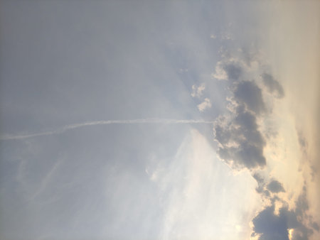 white cloudy sky texture with orange sunlight