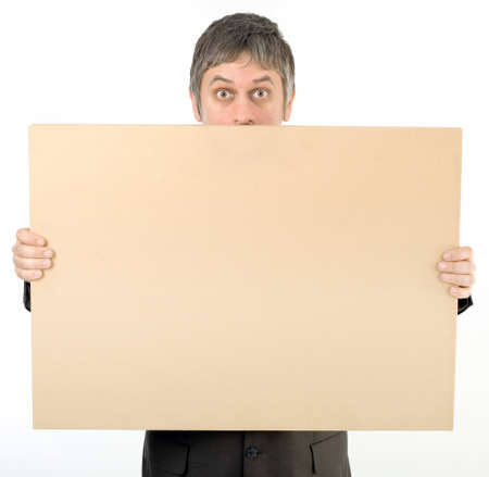 Astonished Staring Adult Man Behind Banner Isolated on White Backgroundの写真素材