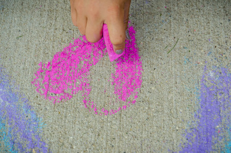 Hand Sketching Heart Drawing on Sidewalkの写真素材