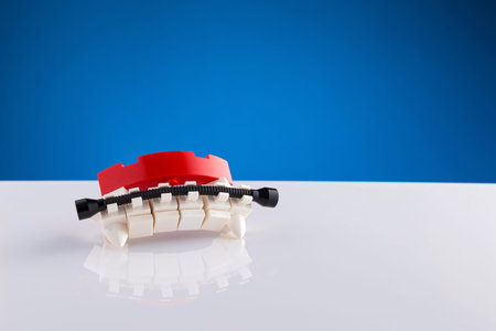 Orthodontics illustration for kids on a white table with a blue background with reflection