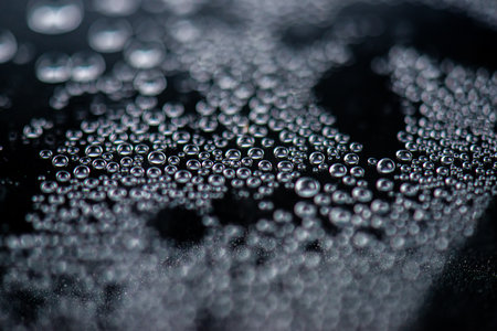Water drops on a black background. Shallow depth of field.の写真素材