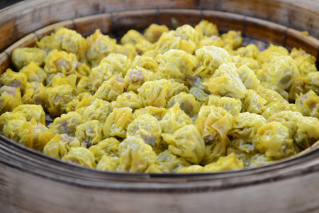 shumai dumpling in bamboo steamer on wooden backgroundの写真素材