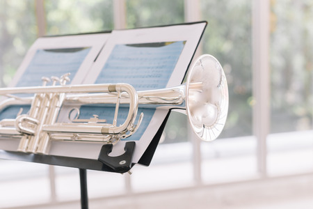 Close - up of trumpet on the musical notes.の写真素材