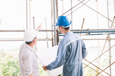 Construction engineers talk to architects at construction sites or buildings.Talking to the construction team at work.の写真素材