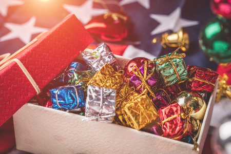 Winter holidays, New Year and Christmas holiday, Colorful gift box placed on a red box with a ribbon.の写真素材