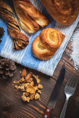 Freshly baked crusty loaves of bread  with flour on a wooden table. Top view.の写真素材