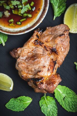 Top view grilled beef steak on a black background with herbs and spices, Piece of cooked rump steak with served.の写真素材