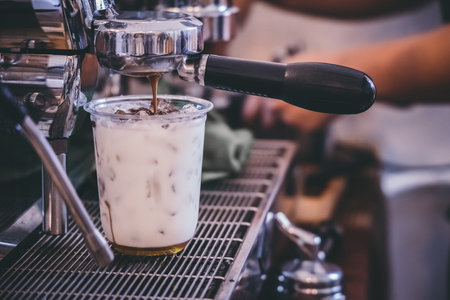 Coffee machine making drink in a cafe, The milk cup is placed on the coffee base. Professional...