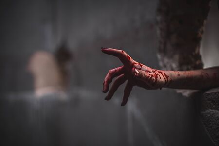 Nightmares of scary fear at the halloween festival. Close up bloody hands protruding from the wall, Horror and terror.の写真素材