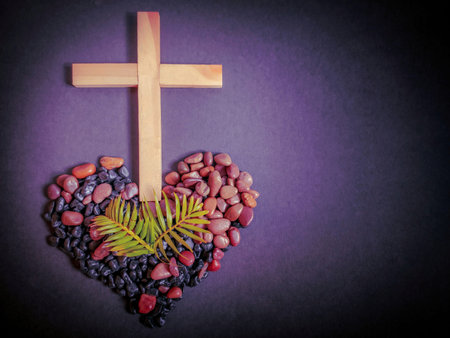 Lent Season,Holy Week and Good Friday concepts - photo of wooden cross with palm leaves and stones...