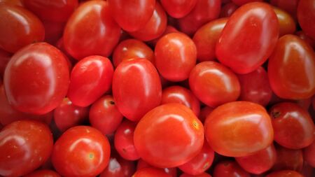 Heap of cherry plum tomatoes in vintage backgroundの写真素材