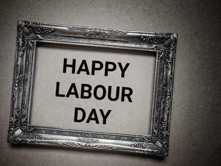 Happy Labour Day text on wall with wooden frame background